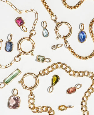 Gold jewelry with gemstones on a white background